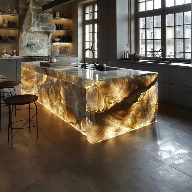 Illuminated translucent stone-effect island with seating in a dark kitchen